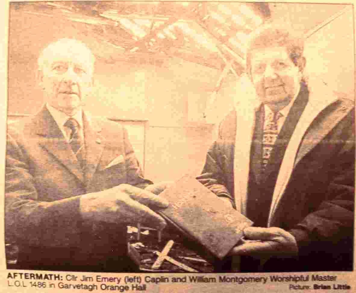 Councillor Jim Emery, Chaplain, left; and William Mountgomery Worshipful Master of LOL 1486 hold the lodge Bible which remains after the Hall was burnt by republicans